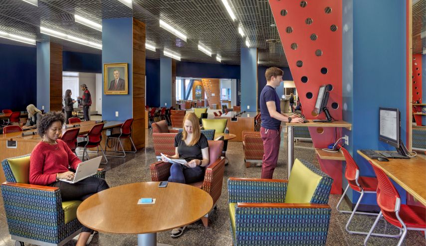 Students studying adjacent to the IT Help Desk in the Buley Library Learning Commons