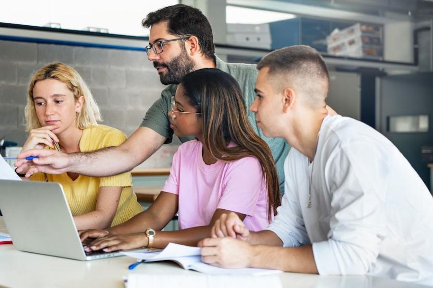 Stock image depicting college students assisting providing technology support