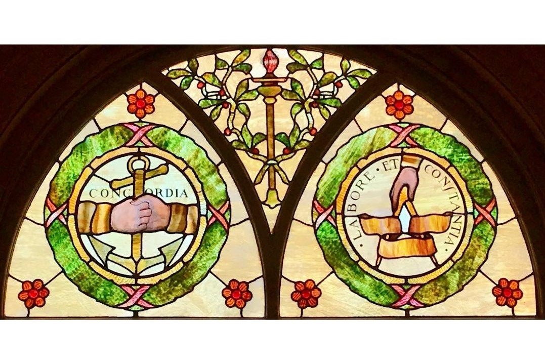 The stained-glass window’s arch.
