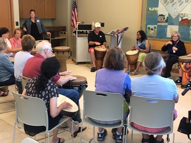 Individuals participating in a drum circle during Memory Café.