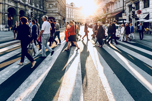 Group of people walking across street, photo by Jacek Dylag on Unsplash
