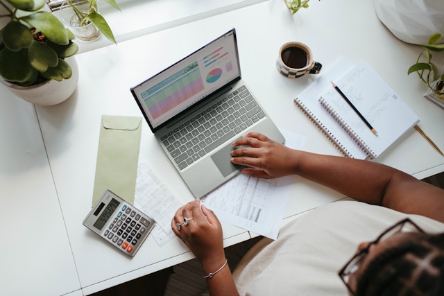 Woman working on spreadsheet from top down view, photo by Microsoft 365 on Unsplash